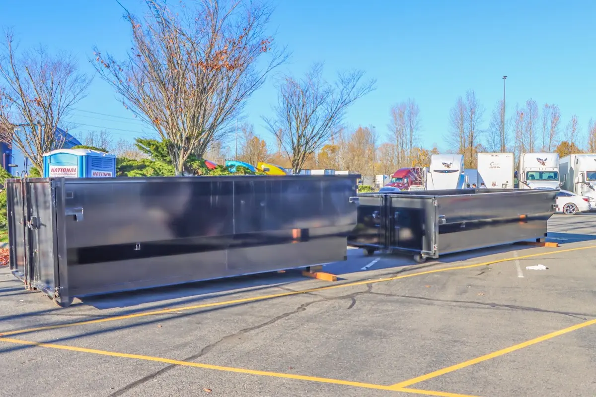 Professional dumpster rental service with roll-off container on residential driveway in Del Aire